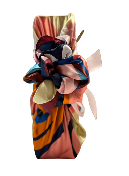 Bright multicoloured silky ladies scarf used as a Furoshiki bottle wrap, full-length view