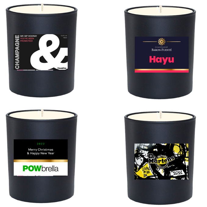 Four black scented candles branded with company logos