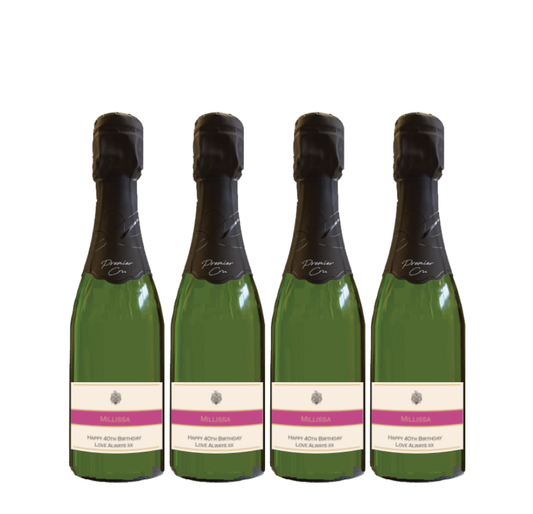 Four mini Premier Cru Champagne bottles with personalised cream labels and a pink band