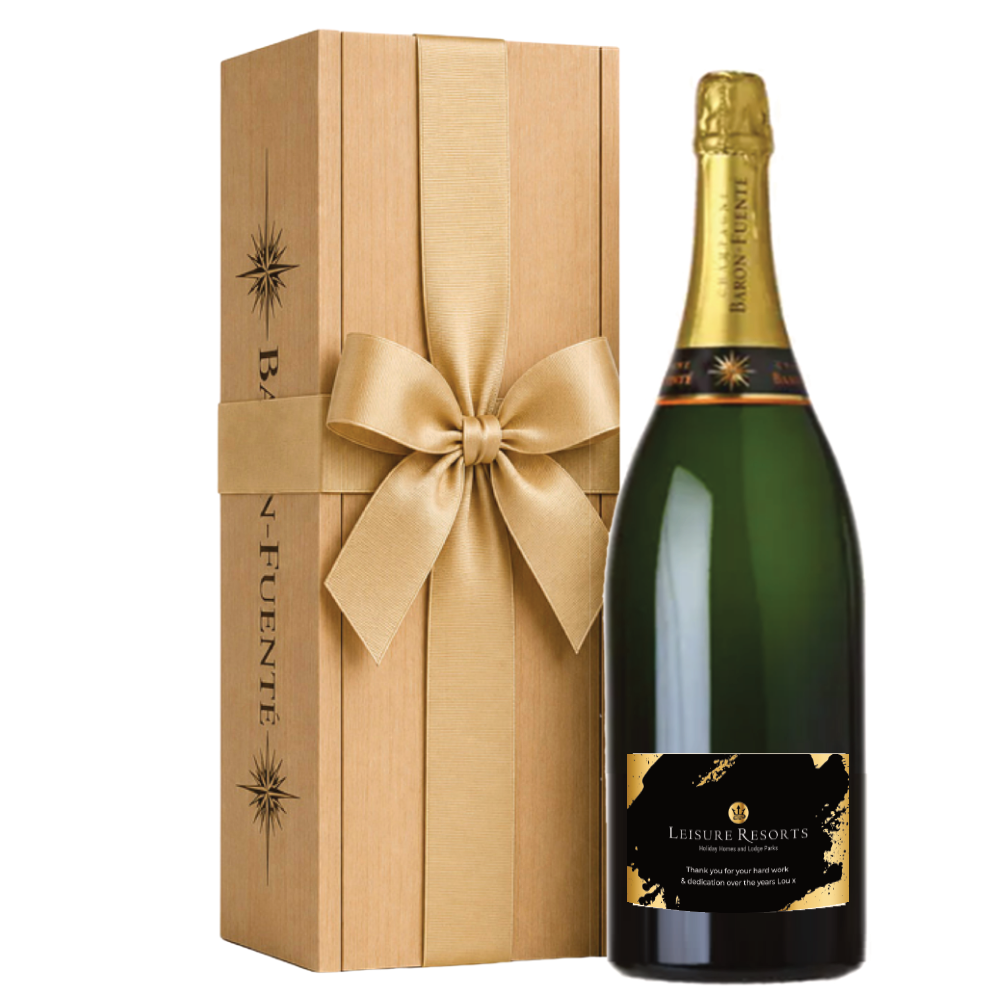 Champagne jeroboam with a black and gold company logo label beside a Baron Fuenté wooden gift box with a large bow