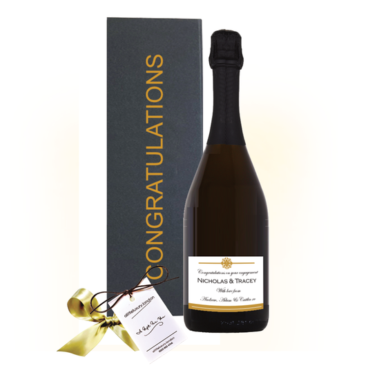 Prosecco branded with logo. Prosecco bottle beside a black gold-lettered Congratulations gift box with a hand-tied bow.