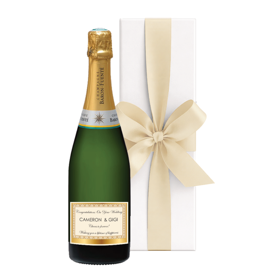 Luxury personalised Champagne gift with gold label showing name and message, beautifully presented in a white gift box with a large hand-tied bow