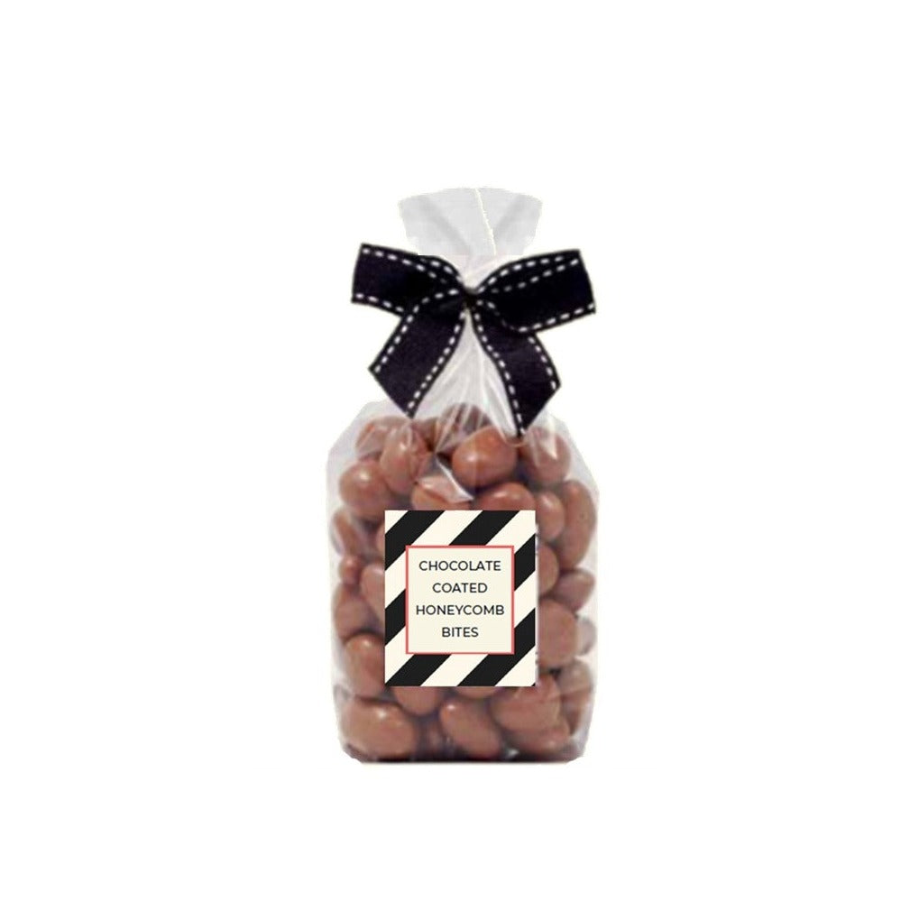 Clear gift bag of milk chocolate coated honeycomb bites tied with a black and white ribbon