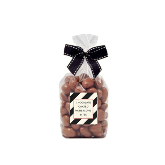 Clear gift bag of milk chocolate coated honeycomb bites tied with a black and white ribbon