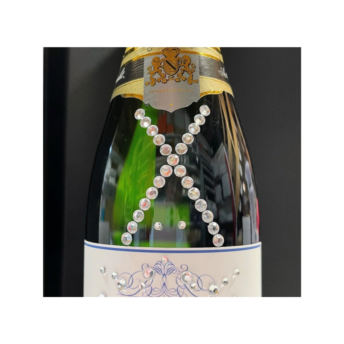 Champagne bottle with a cross of hand-placed crystal gems on the glass, 1 to 10 crystals