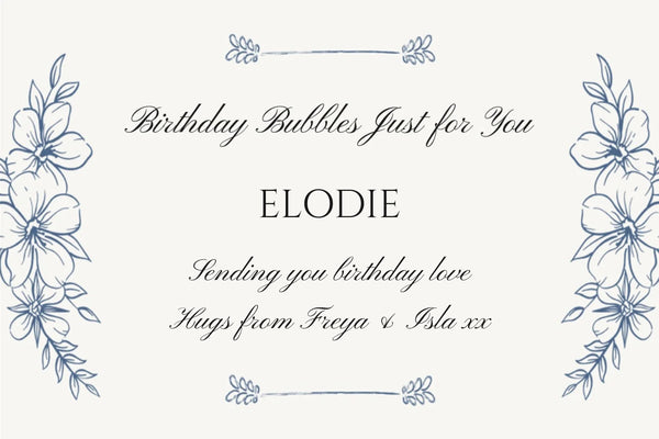 Delicate birthday Champagne label with blue hand-drawn flowers and 'Birthday Bubbles Just for You' in flowing script