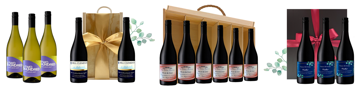 Corporate branded wine gifts — bottles with custom labels in a gift bag, a wooden six-bottle carrier and a black presentation box