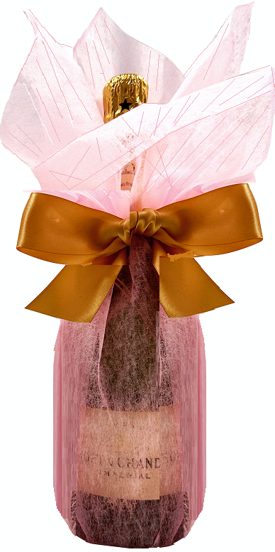 Champagne bottle hand-wrapped in soft blush pink gift wrap, gathered at the neck with a golden satin bow.