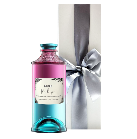 Personalised UKIYO Japanese Blossom Gin in its pink and blue ombré bottle beside a white gift box with a bow
