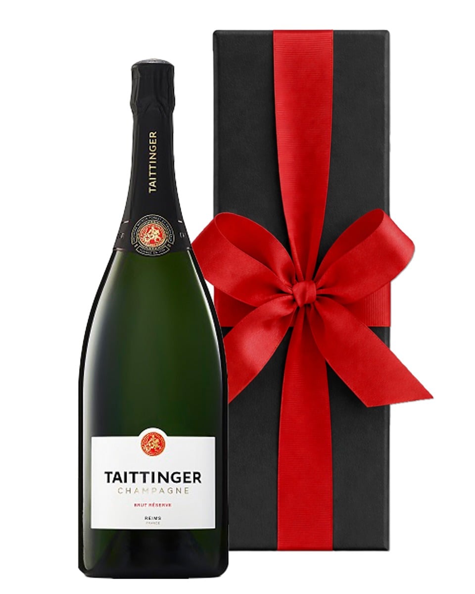 Personalised Taittinger Brut Reserve Champagne magnum with a custom label beside a luxury black gift box with a large bow