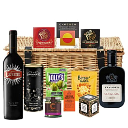 Toscana luxury red wine and treats hamper in a wicker basket with hand-tied ribbon