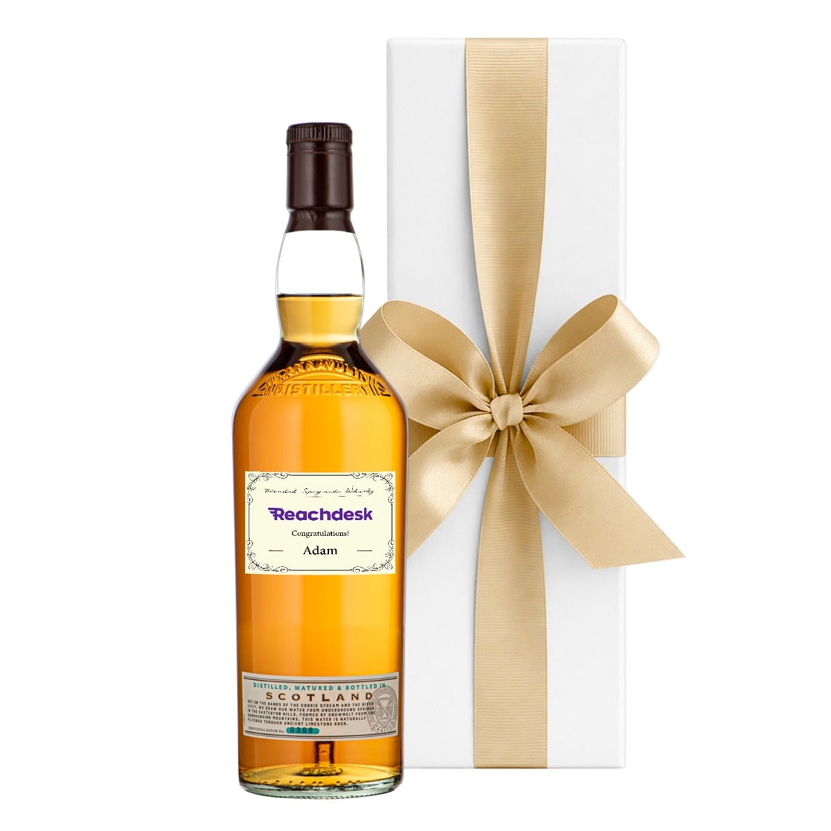 Personalised Speyside single malt whisky with a name and message label beside a luxury white gift box with a bow